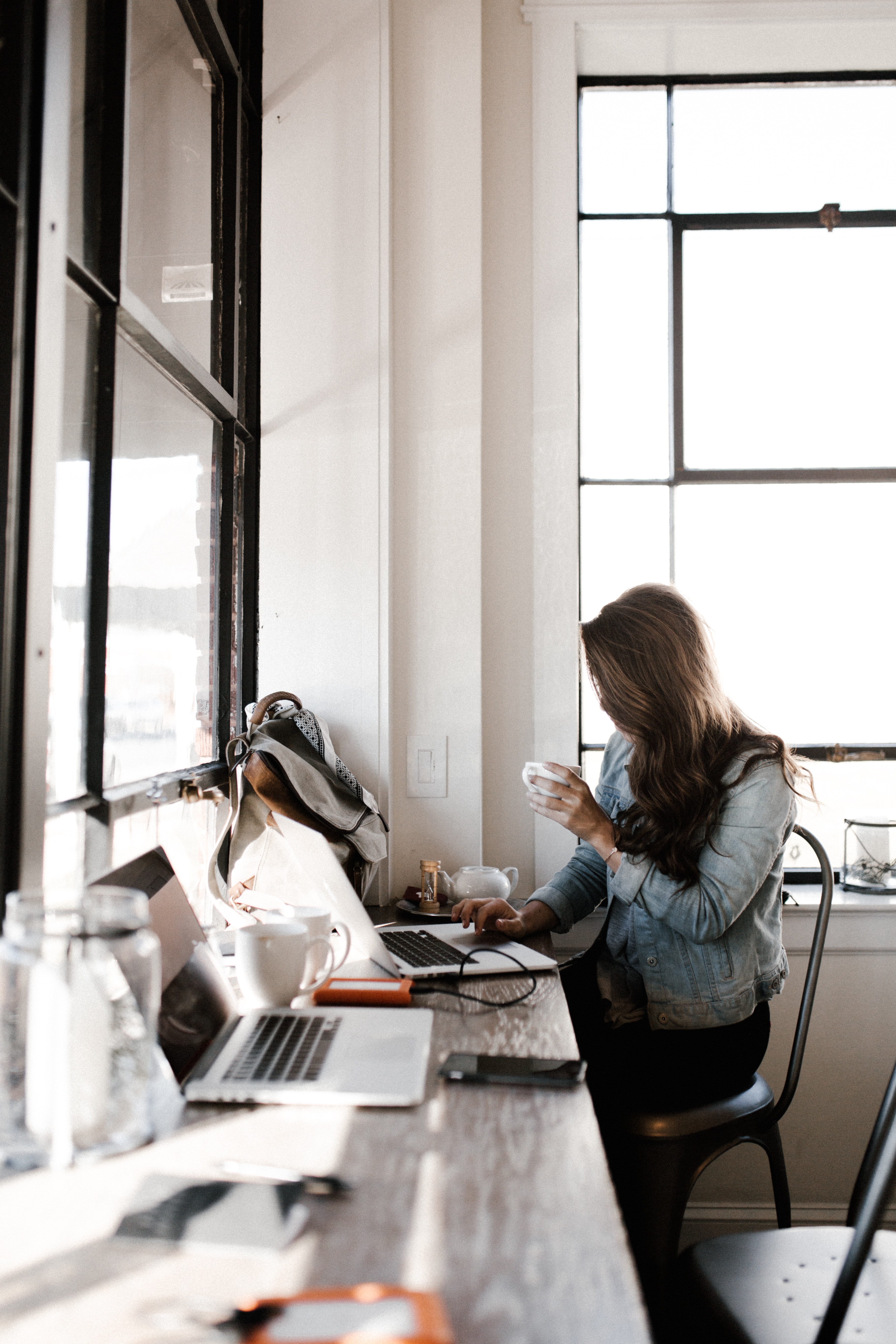 image of
        a lady sitting on a stool working